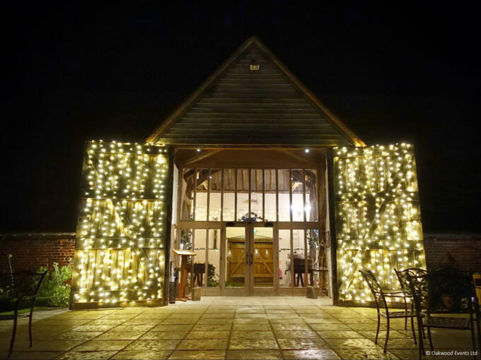 Fairy lights on the barn doors at Ufton Court